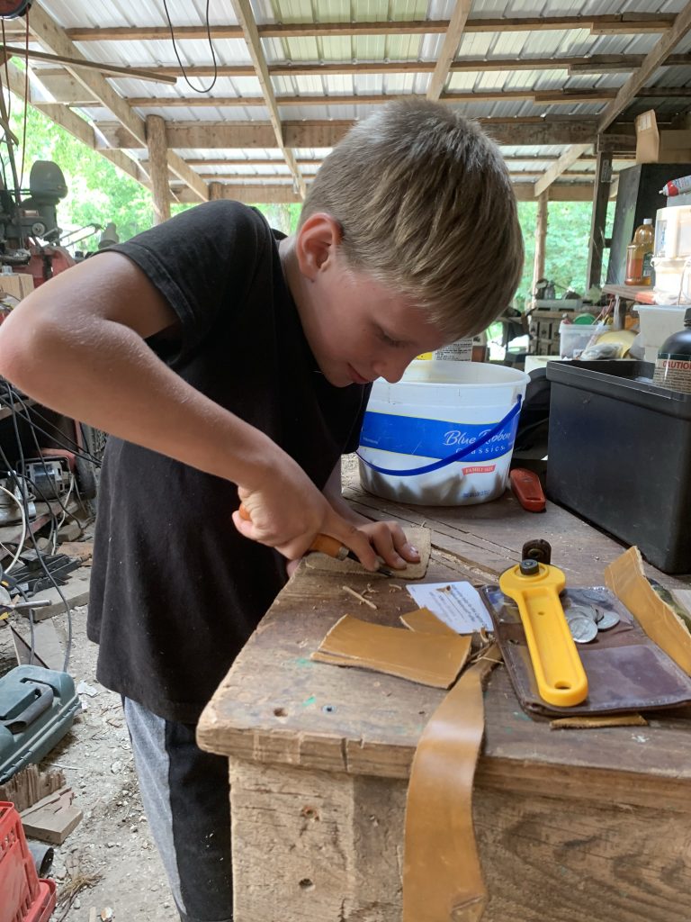 child cutting leather 