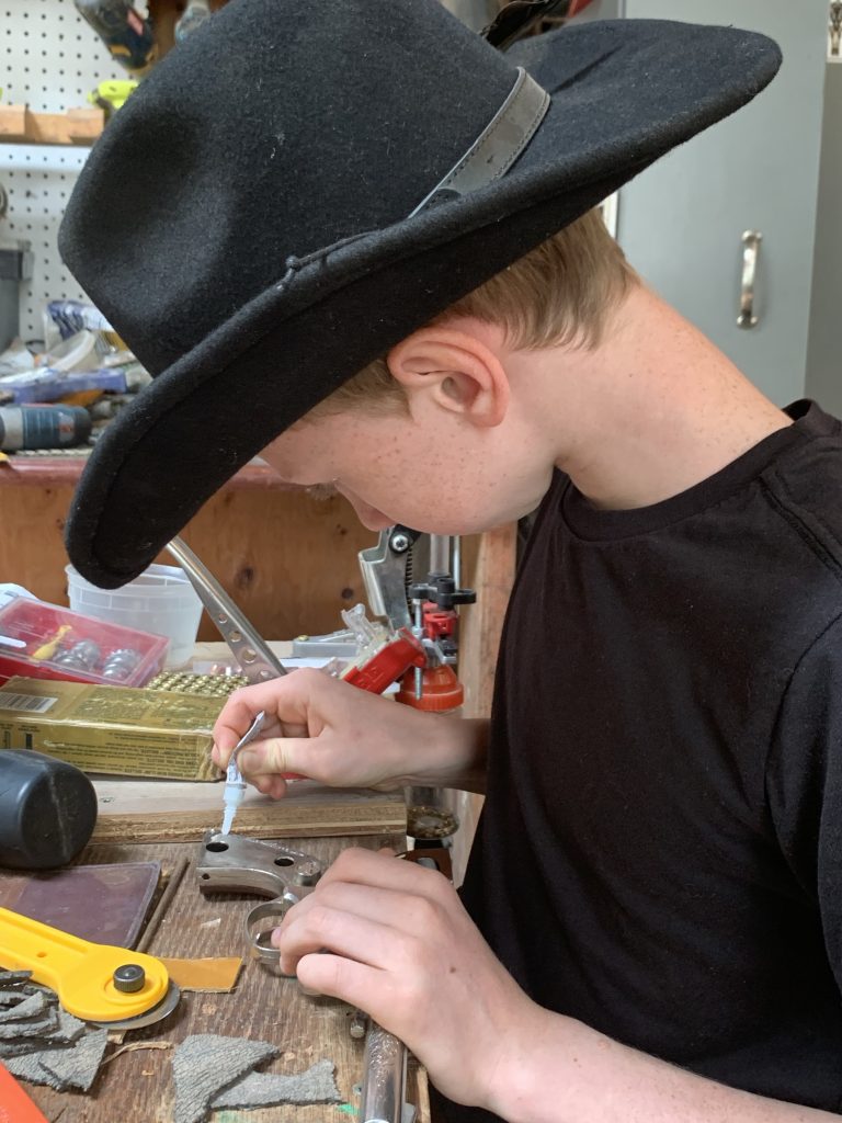 boy with cowboy hat in workshop