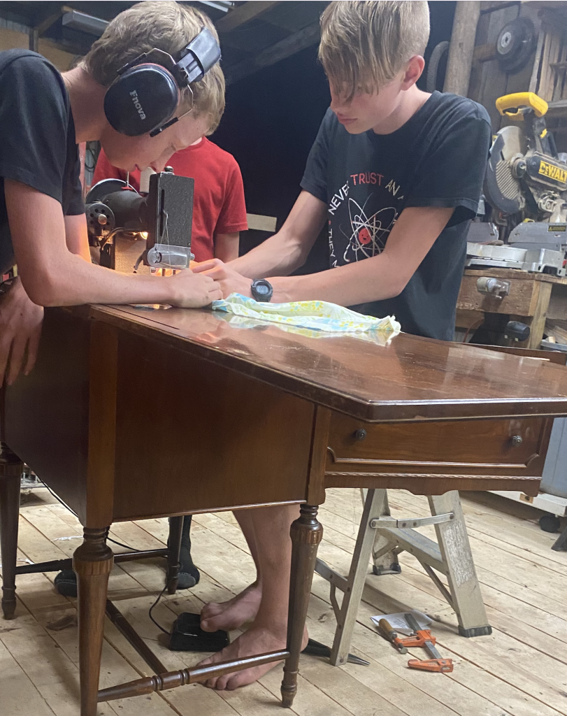 boys sewing leather